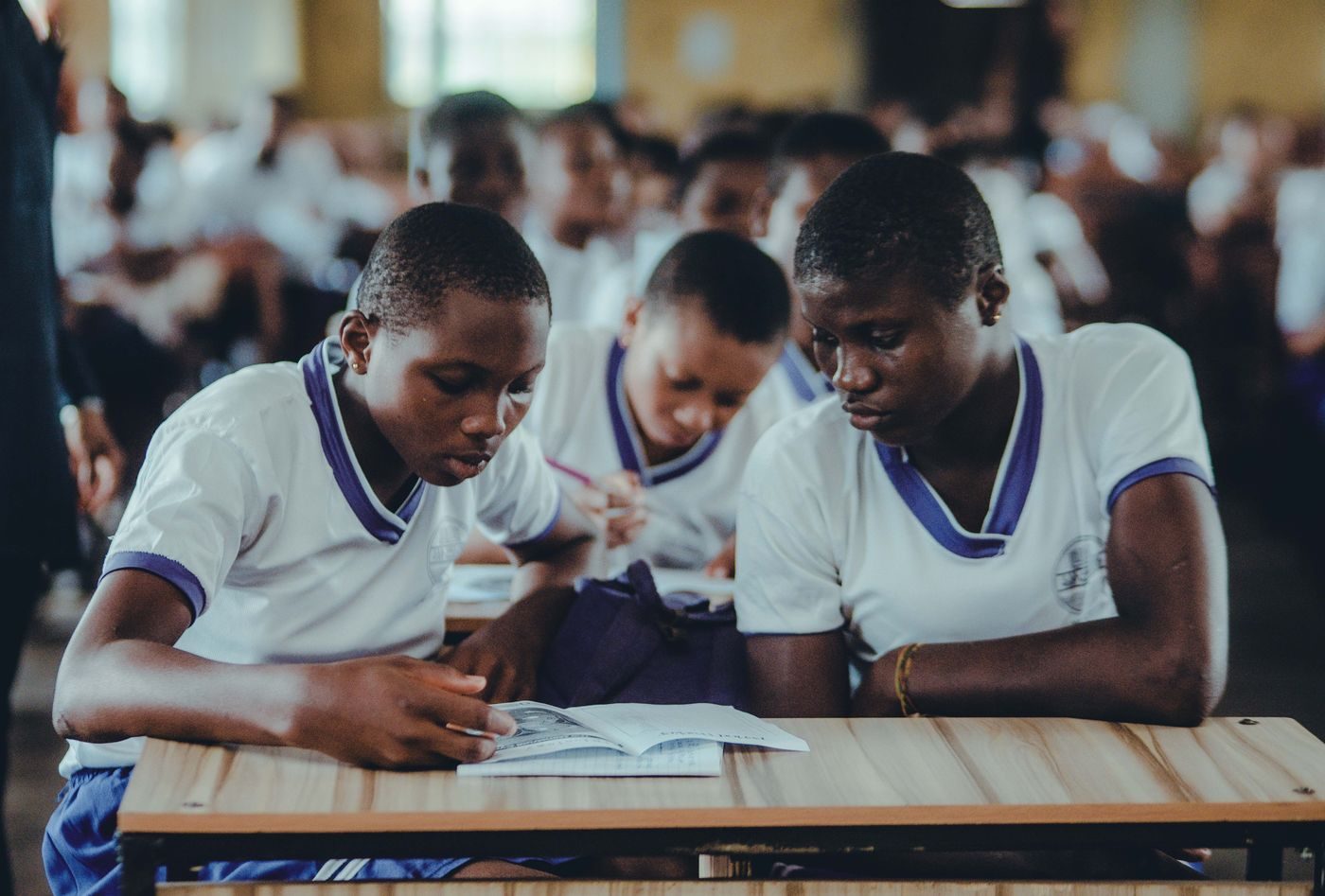 Students in uniform working together in a Zimbabwean classroom