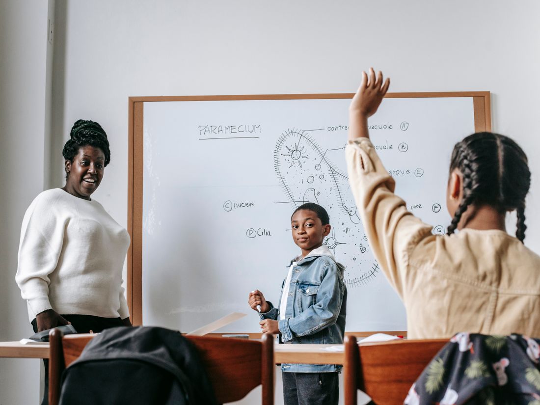 A teacher helping students during a lesson