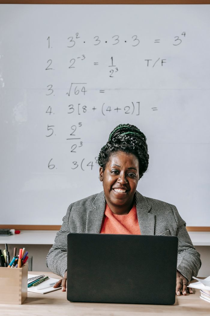 Teacher using a laptop in class